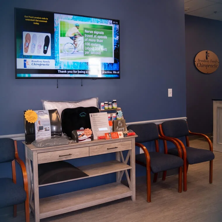 Waiting area with seating and a wall-mounted screen